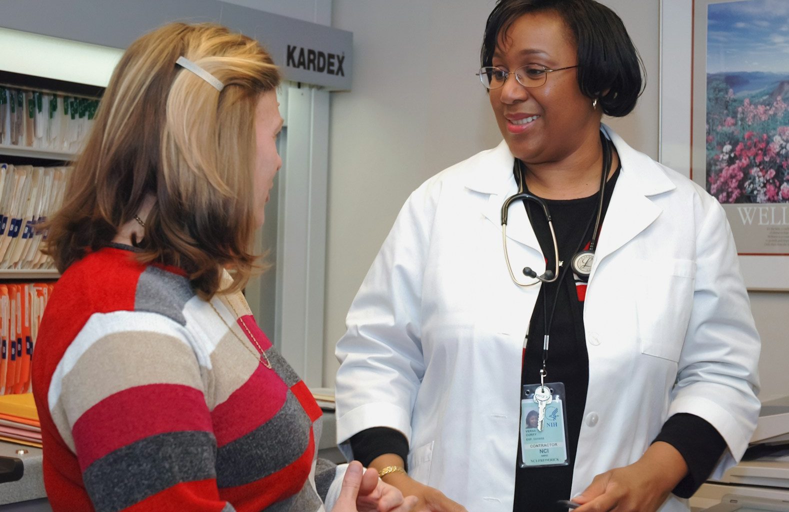 woman in white button up long sleeve shirt holding white card