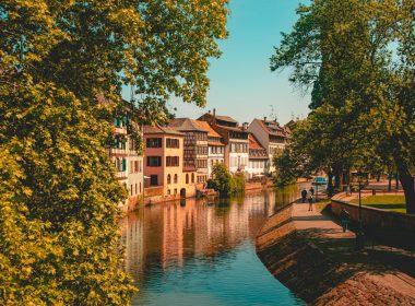 brown and white concrete building near body of water during daytime
