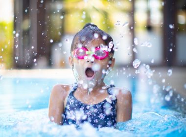 girl swims on swimming pool