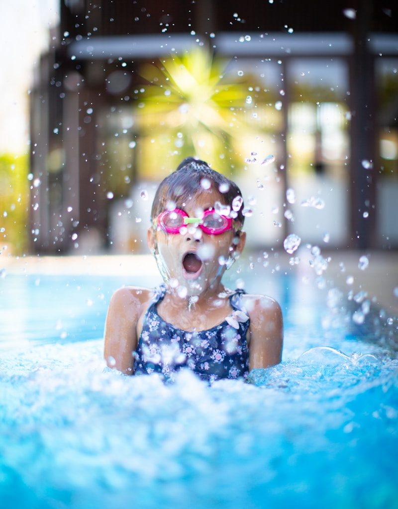 girl swims on swimming pool
