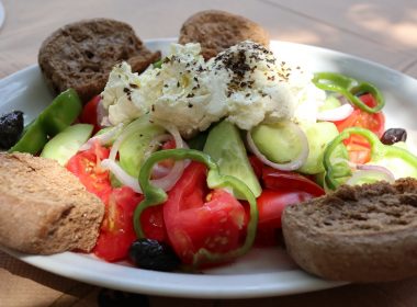 a white plate topped with a salad and bread
