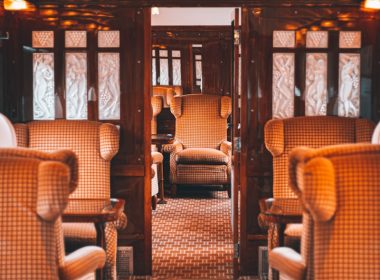 a train car filled with lots of wooden furniture