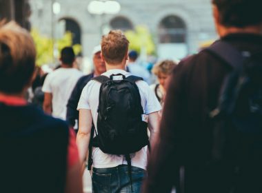 man in black and white shirt carrying black backpack