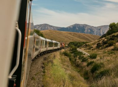 white train with the distance of mountain during daytime