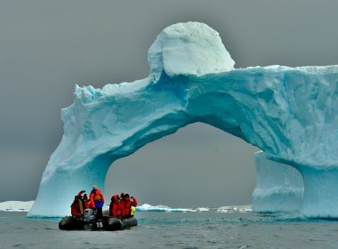 people sitting on ice formation during daytime