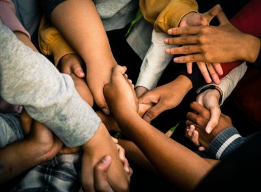 a group of people holding hands