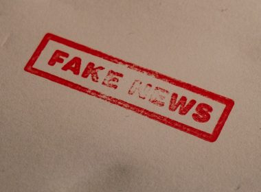 a stamp that reads fake news on a piece of paper