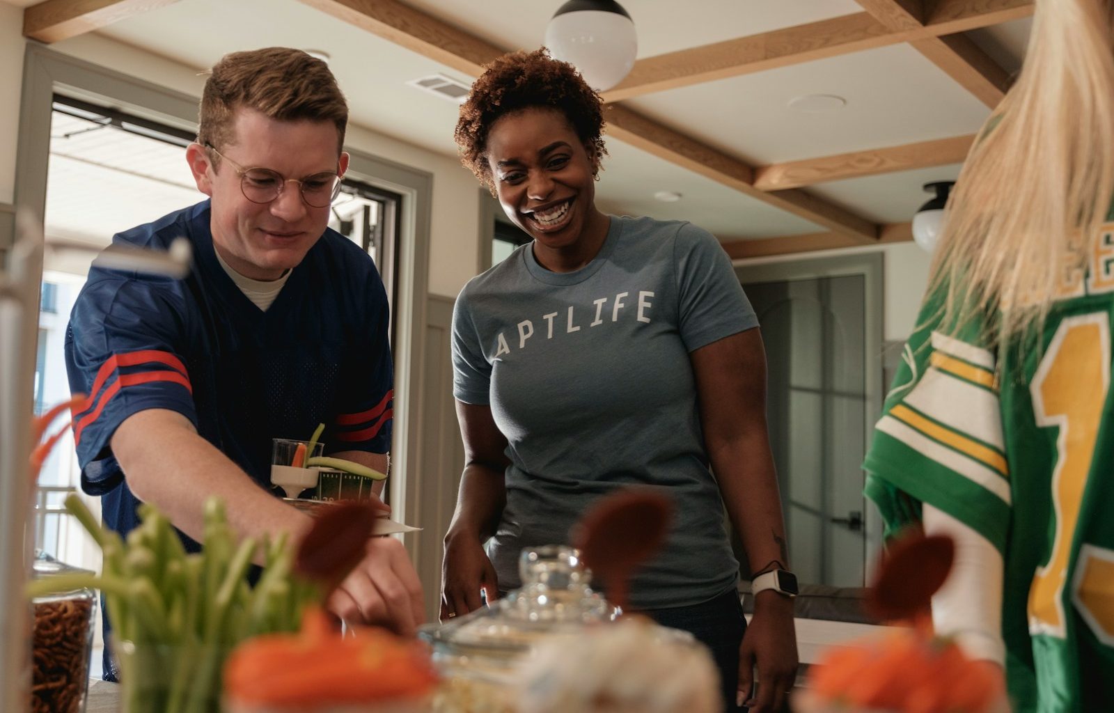Two people preparing food at a table