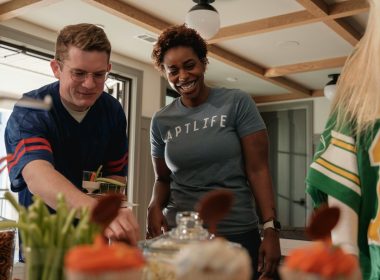 Two people preparing food at a table