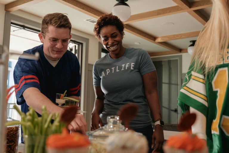 Two people preparing food at a table