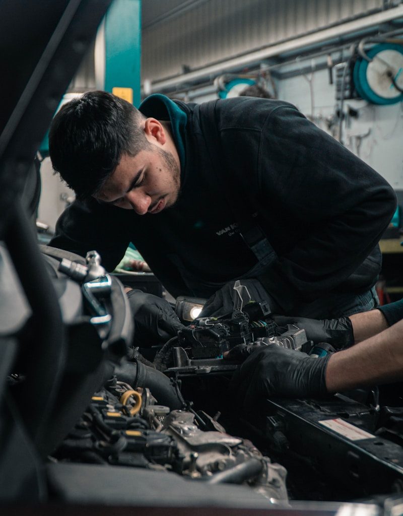man in black jacket and blue denim jeans riding motorcycle