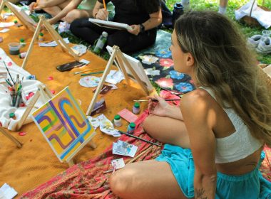 People painting outdoors at an art class.