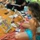 People painting outdoors at an art class.