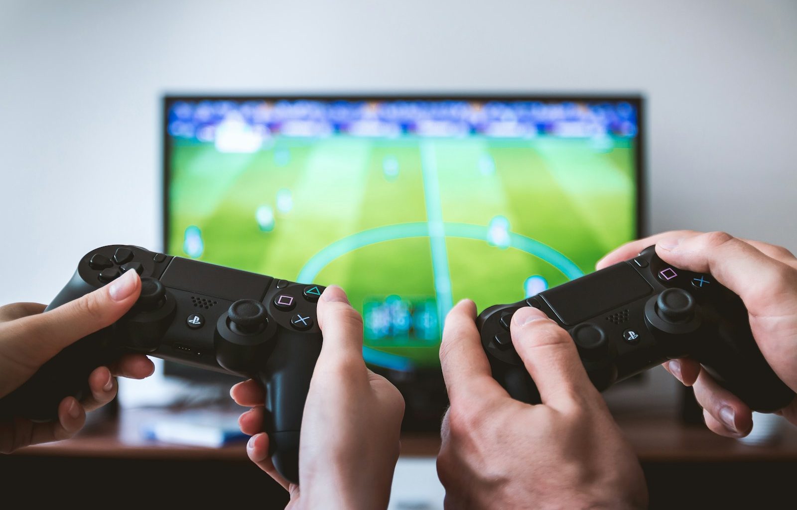 two people playing Sony PS4 game console