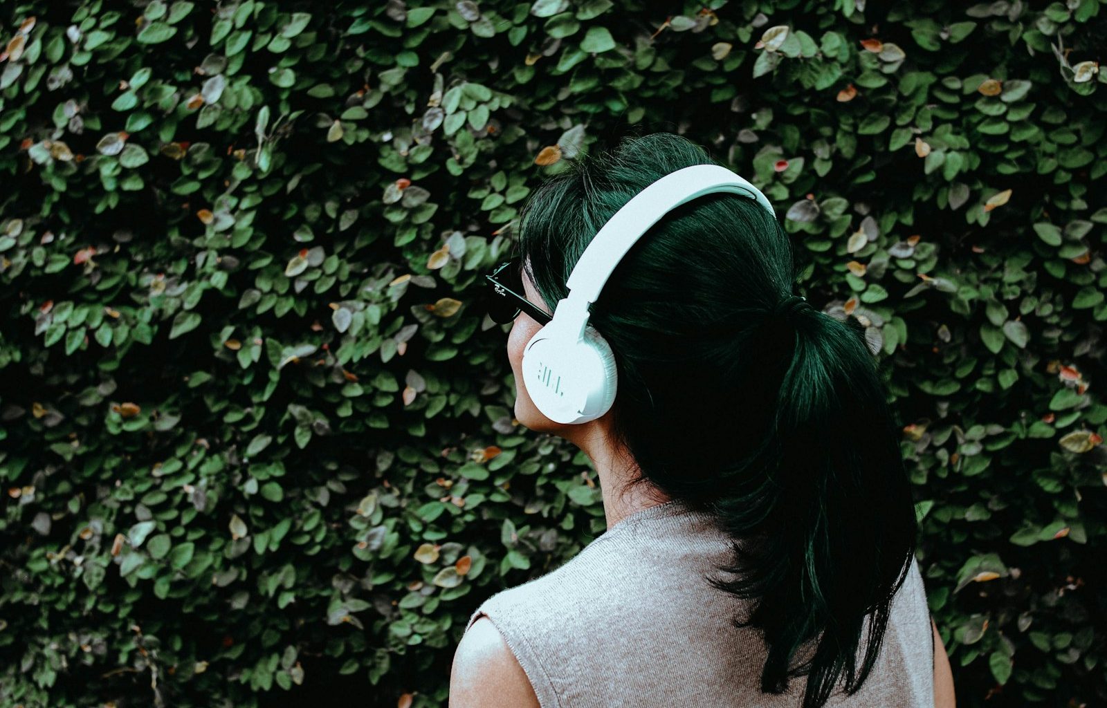 person using white headphones