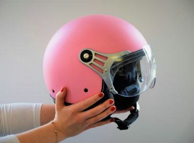 person holding pink helmety