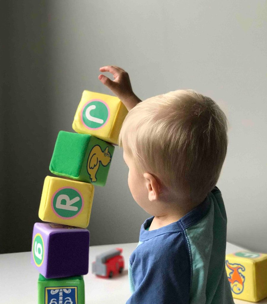 boy playing cube on white wooden table