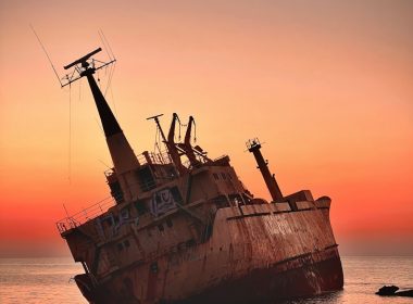 an old rusted ship in the middle of the ocean