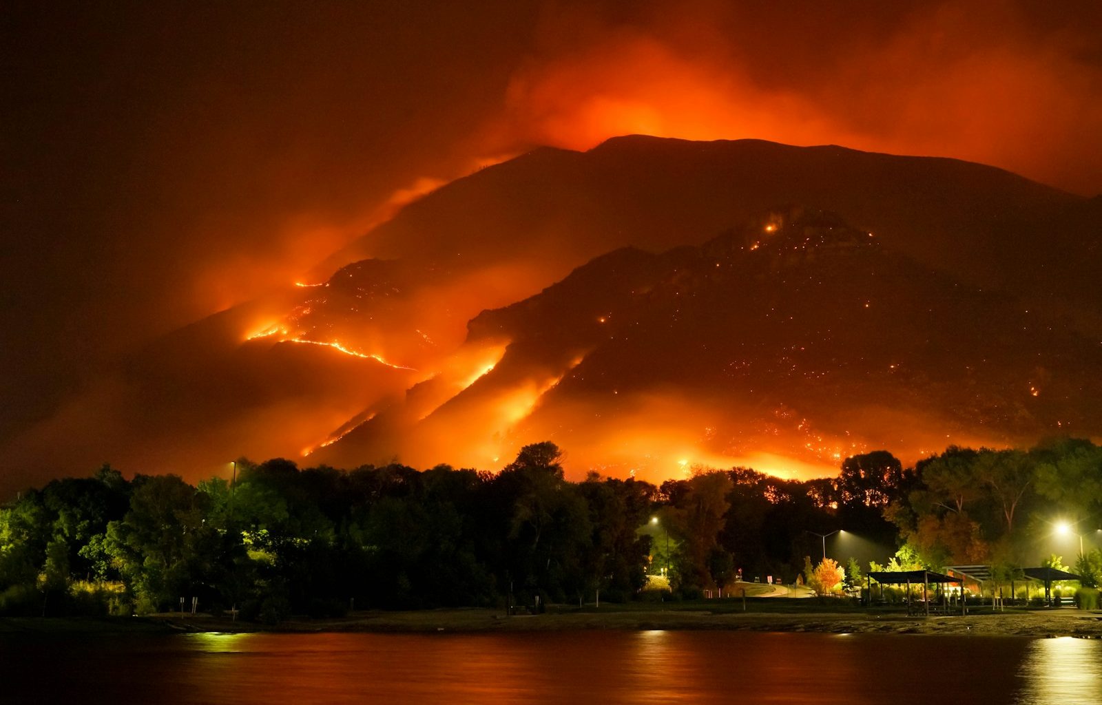 a large fire is burning in the mountains