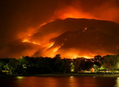 a large fire is burning in the mountains
