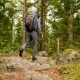 a man with a backpack is hiking through the woods