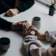 two people holding hands at table
