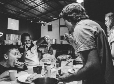 grayscale photography of people eating food