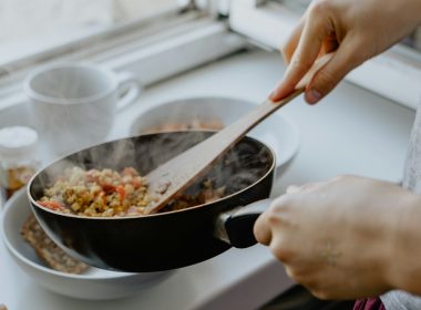 person holding black frying pan