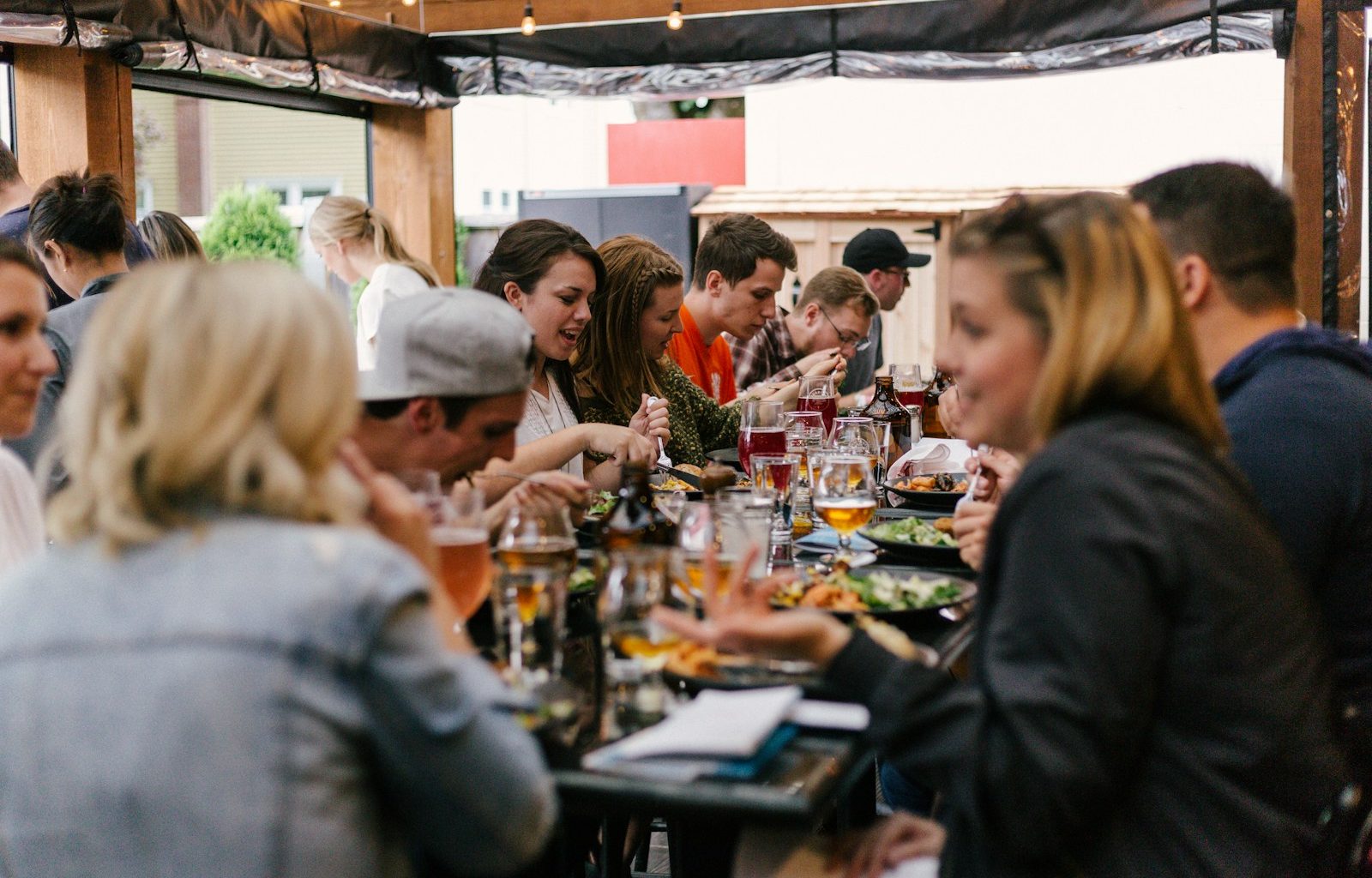 people sitting in front of table talking and eating